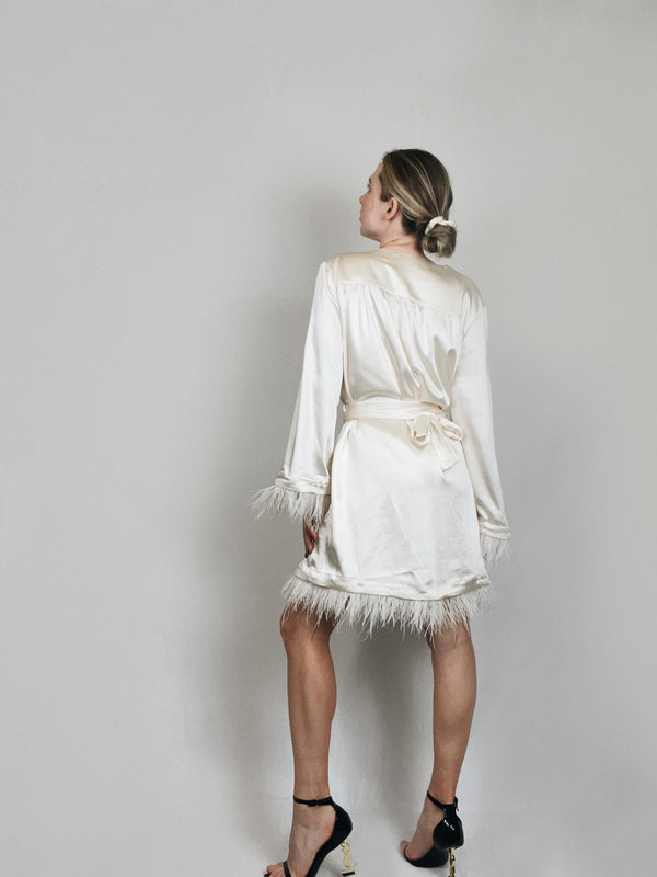 Back view of ivory satin robe showing soft drape and length
