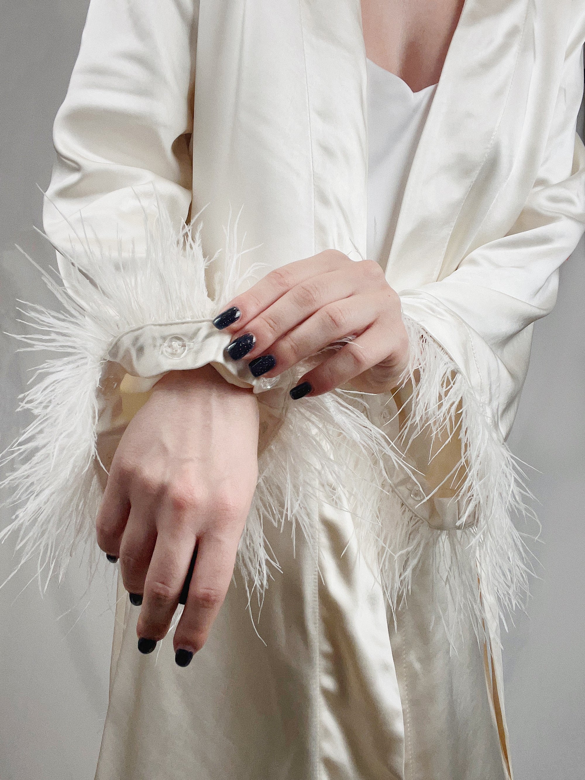 Close-up of detachable feathers on sleeve 
