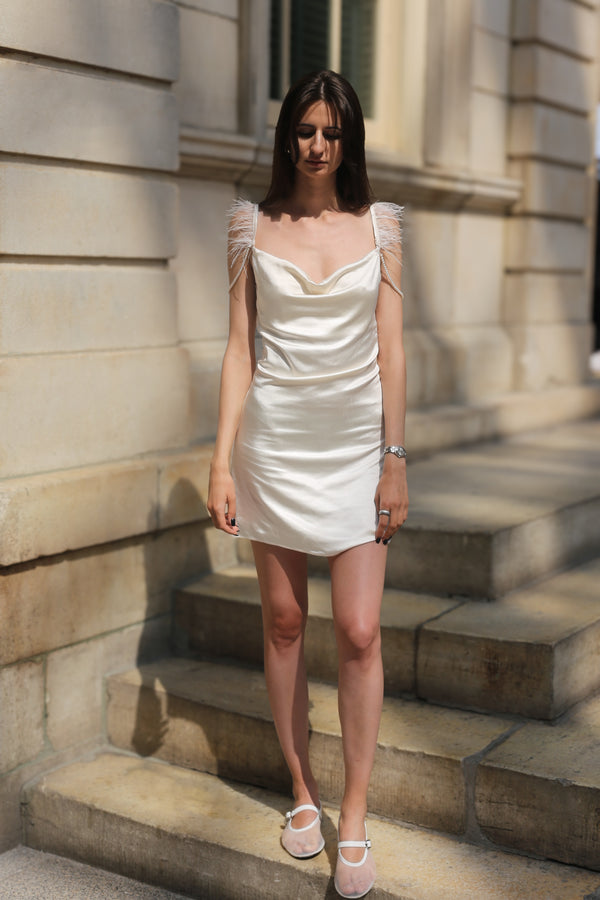 Front view of ivory satin mini dress on model, showing adjustable straps
