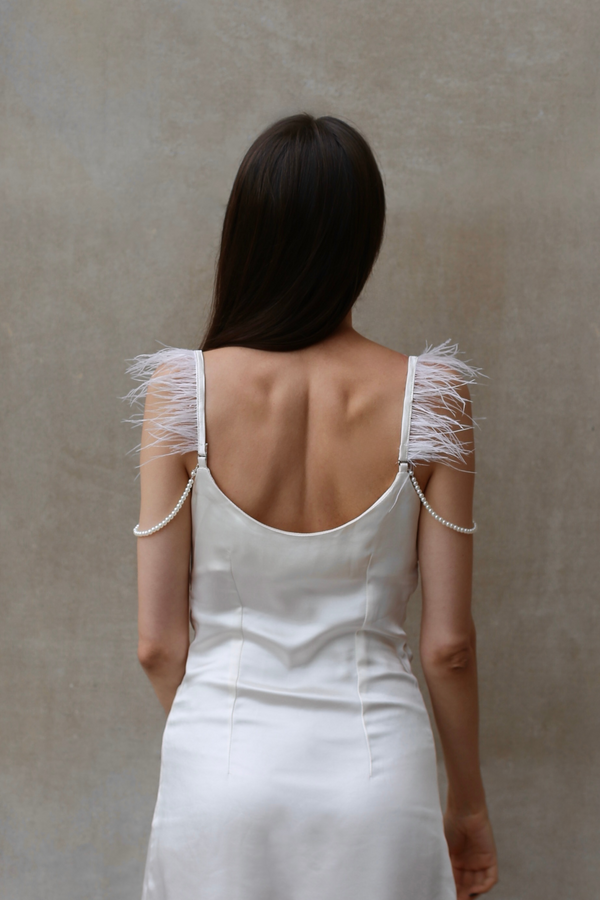 Back view of ivory satin mini dress with low back and satin finish