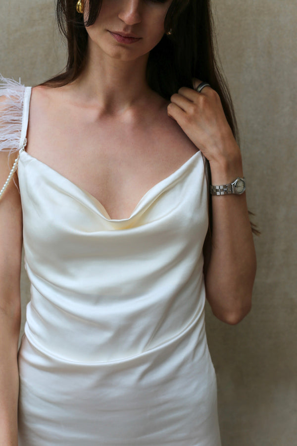 Ivory satin mini dress styled for a daytime look with sneakers