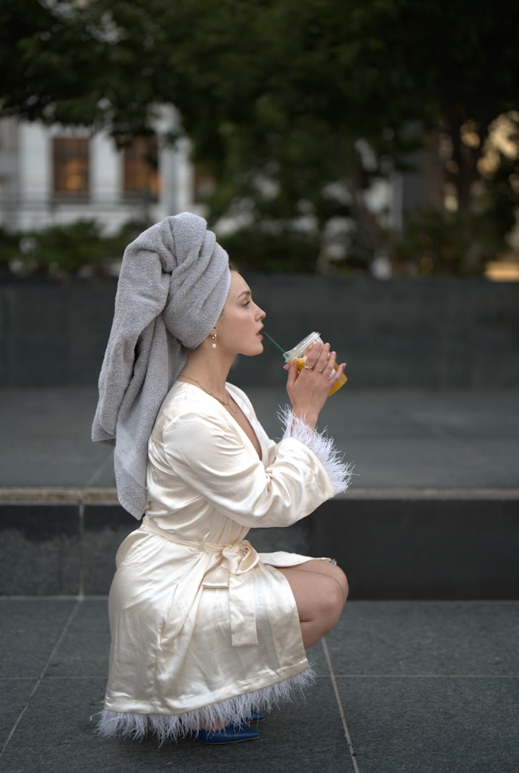 Model seated in ivory robe, soft light and relaxed vibe