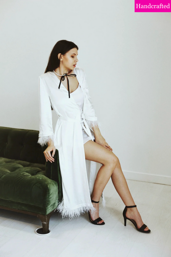 Side view showing robe’s full length and detachable feathers