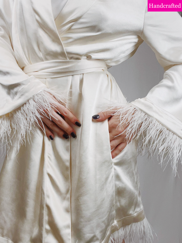 Close-up of detachable feathers on sleeve or hemline